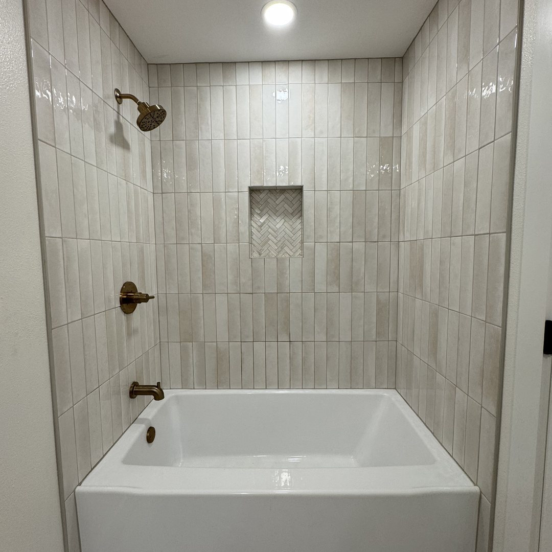 Guest bathroom renovation with tiled tub and shower surround, New Port Richey, FL